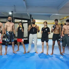 A snapshot of our warriors, a mix of seasoned fighters and young up-and-comers, all standing together with their coaches. This is the strength of our club.