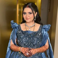 A modern reception night glow. This bride looks absolutely regal in her embellished blue gown, with soft glam makeup and glossy lips to complete the look.