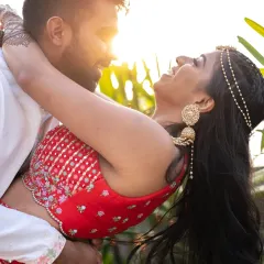 A sun-kissed, playful moment during the Mehendi ceremony. The golden light and their laughter make this a perfectly candid and happy shot.