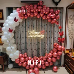 An intimate and elegant 50th anniversary celebration at home. We used a semi-arch of metallic red and white balloons with butterfly accents and a custom neon sign.