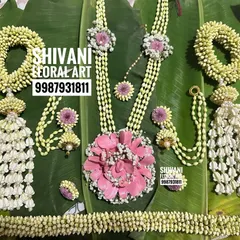 A full baby shower set featuring a large, intricate lotus-shaped pendant made from pink flower petals, surrounded by Tagar buds.