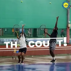 Two players practice their serves in unison, a great example of the focused training environment at our facility. Repetition and practice are key to mastering the game.