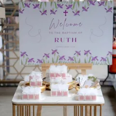 The welcome table for Ruth's Baptism. I create a cohesive experience, from the main backdrop to the smaller details like the welcome sign and favor table.