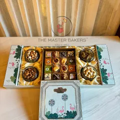 This expansive gift box is designed to impress corporate clients, featuring a beautiful flamingo motif. It opens to reveal four jars of assorted dry fruits and a central compartment filled with our signature baklava and other sweets.