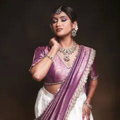 This look showcases my skill in both hairstyling and modern saree draping. The dupatta is draped elegantly over a lehenga skirt, paired with a sophisticated updo.
