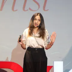 A close-up from the TEDx stage. I spoke about how my passion for storytelling and community relationships has guided my work, from painting in Mumbai slums to my all-India tour.
