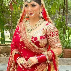 A close-up of my classic HD bridal makeup. I focus on creating a flawless, radiant base that looks stunning in photos and lasts all day. Notice the defined eyes and perfectly blended skin, creating a timeless look for this beautiful bride in her red lehenga.