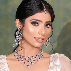 A clean and elegant look for a reception or cocktail party. The focus is on the beautiful diamond and ruby jewelry, paired with a simple, chic makeup look.