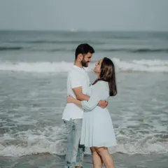 A romantic embrace in the gentle waves of the sea. This kind of shot captures the intimacy and connection between a couple.