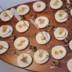 A minimal, design-driven tablescape created for architect Rooshad Shroff. The focus is on the clean lines of the plates and the simple, elegant arrangement of food, allowing the design to speak for itself.
