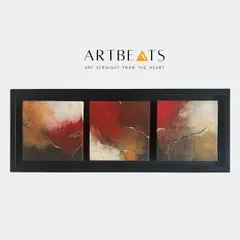 A full view of the framed 'Kintsugi-II' triptych. The dark frame provides a stark contrast to the warm, earthy tones and delicate gold lines within the paintings, emphasizing the idea of mending and healing.