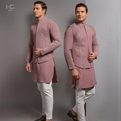Redefining tradition with grace. This dusty rose Indo-Western set features a layered, structured jacket over a matching kurta, creating a soft yet strong silhouette.
