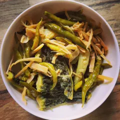 A simple and healthy Naga-style boiled vegetable dish. It features bitter gourd and green chilies boiled with shredded bamboo shoots for a tangy, spicy flavor.
