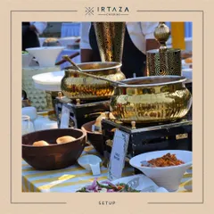 A daytime buffet setup for a home party, featuring my golden chafing dishes on a cheerful yellow and white striped tablecloth. This shows how I can create a bright and festive mood for any celebration.