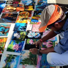 My collection of tiny paintings spread out at Chitra Santhe, attracting art admirers of all ages. These small canvases are a great way to start your art collection.