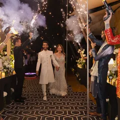 Couple entries should be grand and energetic. For this Sangeet, I planned a sparkling entrance with guests holding cold-pyro guns, creating a tunnel of light for the couple to walk through.