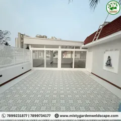 Another angle of the transformed terrace, showing the seamless integration of the indoor and outdoor areas with large sliding glass doors. The white lattice fence provides privacy while keeping the space bright.