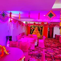 The same pink-themed hall under different lighting, showing how coloured lights can change the mood of the space.