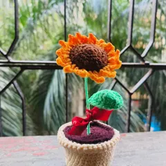 A close-up of the potted sunflower, showing the small red ribbon tied to its stem. It's these tiny details that I love adding to my creations.