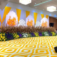 A bright and cheerful stage I created for a Haldi or Mehendi ceremony. The design uses a yellow and white color scheme with dried pampas grass and beds of fresh flowers.