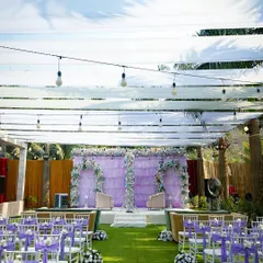 A beautiful daytime Nikah setup with a soft lavender theme. The open-air design with flowing drapes and floral arches creates a serene and blessed environment for the ceremony.