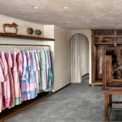 For the Eka fashion boutique in a Mumbai heritage building, we embraced a narrative of nostalgia and comfort. This space balances raw concrete floors with the warmth of natural wood displays and custom almira-style wardrobes, creating an intimate, home-like feel that reflects the brand's timeless values.
