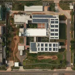 This aerial view shows the scale of our sustainable design for the Fanuc India factory in Chennai. We integrated large arrays of solar panels on the rooftops to maximize energy efficiency. The layout also includes green spaces and courtyards, demonstrating how industrial architecture can coexist with and benefit from bioclimatic design principles.