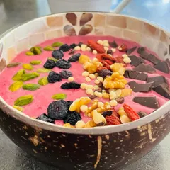 A vibrant and nutritious smoothie bowl packed with fruits, nuts, and seeds. I believe that eating well is an act of self-respect and a crucial part of a disciplined, healthy lifestyle that supports a strong yoga practice.