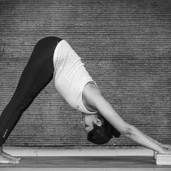 Placing blocks under the hands in Adho Mukha Svanasana, or Downward-Facing Dog, can make the pose more accessible if you have tight shoulders or hamstrings. It helps to lengthen the spine and reduce pressure on the wrists.