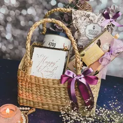 My "Tyohaar" basket offers a sustainable yet elegant gifting option. It features a curated selection of gourmet popcorn and snacks in a handmade cane basket, accented with a "Happy Diwali" card and a beautiful candle.