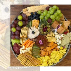 Elegance served on a plate. This platter is a beautiful assortment of crackers, cheeses, fresh fruits, and nuts, perfect for a small, sophisticated get together.
