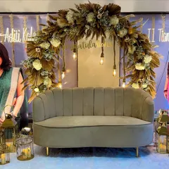 We were so honored to celebrate two brilliant sisters with this custom boho-chic decor. The setup features a lush arch of dried pampas grass and white florals, warm Edison bulb lighting, and elegant lanterns to create a sophisticated and celebratory atmosphere.