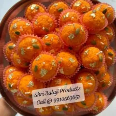 A close-up of my handmade Boondi Ladoo candles. They are crafted with soy wax and decorated with silver vark and pistachio details, making them look just like the real sweet.
