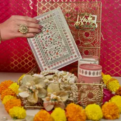 This gold mesh box is crafted for refined celebrations. Here, it's shown with a floral greeting card, premium cashews and almonds, and jars of coffee and cookies, creating a sophisticated Diwali gift.