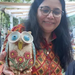 It brings me so much joy to see my creations, like this floral owl vase, find a loving home. This happy customer picked it up at the Ahmedabad Potter's Market.