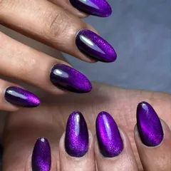 A custom mulberry jelly cat eye shade that I created for a client. This advanced technique gives the nail a deep, magical glow that shifts from purple to pink under the light.
