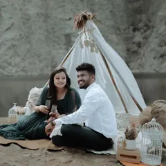Creating a cozy, bohemian-themed picnic setup for a pre-wedding shoot. This shows how we can style a session to match your vibe, complete with props like a teepee and pampas grass.
