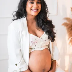 The radiant glow of a mother-to-be. I love capturing the quiet strength and beauty of pregnancy. This portrait, with its clean, modern feel, focuses on the beautiful bond between a mother and her unborn child, a simple and powerful moment of anticipation.