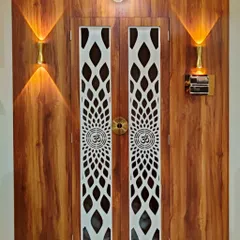 Another angle of the mandir doorway, showing the fine details of the CNC-cut panels and the rich texture of the wood laminate. This is a complete unit designed and installed by my team.