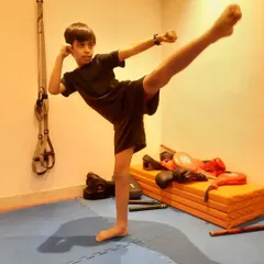 A clean, powerful side kick from a young martial artist. This pose demonstrates great form, balance, and active flexibility, which are core components of our Kung Fu training for kids.