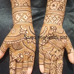 This full-hand design showcases a variety of intricate patterns, from florals and paisleys to checks and lines. It's a great example of a detailed and traditional mehndi style.