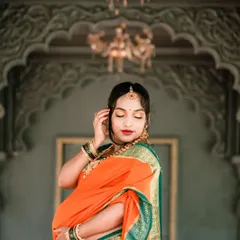 An elegant solo portrait of the mother-to-be during her traditional maternity shoot. Her graceful pose and the ornate background highlight the beauty of this special time.