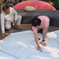 The journey of creating a custom center table. It all starts with a simple drawing on the ground at the workshop, mapping out the organic shape before bringing it to life.