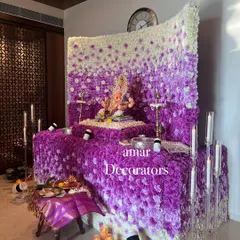 My ombré floral walls are a huge hit for Ganesh Chaturthi. This mandap showcases a beautiful gradient of purple and white flowers, creating a dense, luxurious backdrop for Bappa. The design is complemented by modern candle stands for a soft glow.
