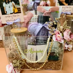 Another view of the personalized bridesmaid hamper, showing the custom name tag for 'Ayushee'. I work with you to select items that your friends will love and use, telling a story of your friendship.