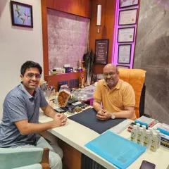 It's always a pleasure to guide clients toward a better path. Here, I am discussing a personalized numerology report with a client, helping him understand his strengths and challenges.