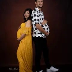 Who has the bigger bump? We love it when couples bring their sense of humor to the studio for fun and playful shots like this.