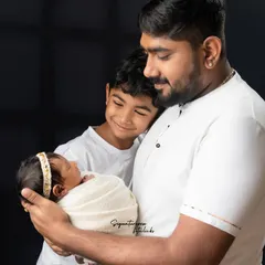 A father's gentle hold and a big brother's loving gaze. This portrait captures the beautiful moment a family welcomes its newest member. We travel across South India for on-location shoots like this one in Andhra Pradesh.