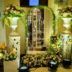 For Aishwarya and Mihir's ring ceremony, I designed this elegant mirrored welcome sign with their custom monogram, framed by a delicate arch of fresh greenery.