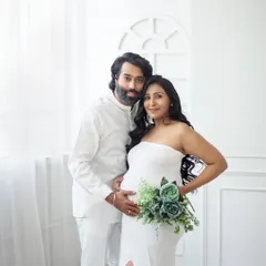 Simple, elegant, and full of love. This portrait uses a minimalist white backdrop to keep the focus entirely on you and your beautiful bump.